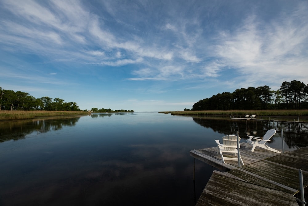 two adirondack chairs by the water at our Rock Hall Bed and Breakfast on the Chesapeake Bay