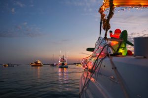 lighted christmas boat parade on water