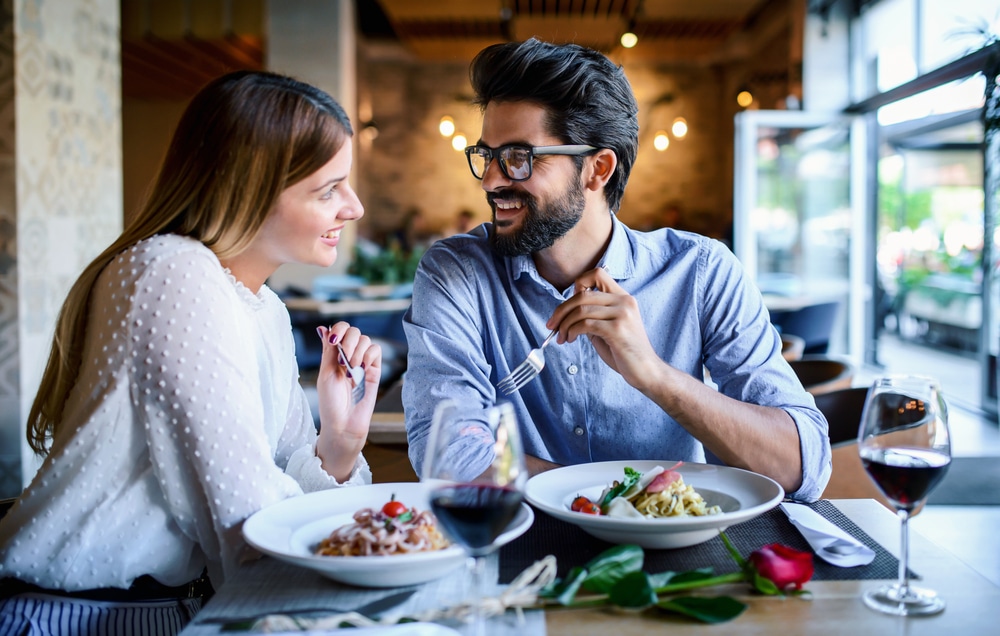 A man and a woman enjoying a meal at the best Rock Hall, MD Restaurants in 2023