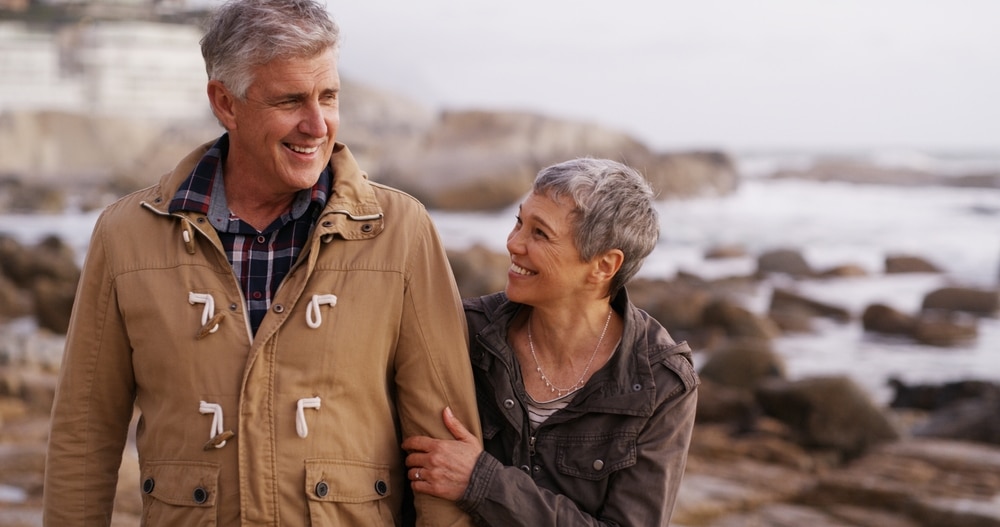 Couple enjoying a walk by the shoreline on their weekend getaways from Baltimore